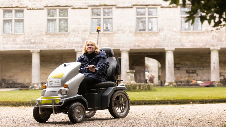 Visitor exploring the garden on mobility tramper at Godolphin,